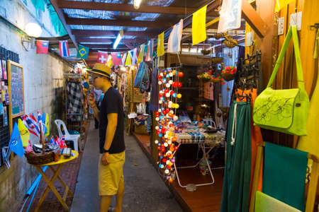 BANGKOK, THAILAND - MARCH 22: Unidentified tourist chooses souvenirs at the famous backpackers destination Khao San Road at night on March 22, 2014 in Bangkok, Thailand.のeditorial素材