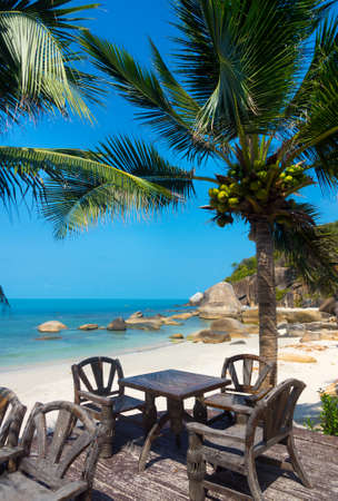 Table in a restaurant on the beach in tropical resortの写真素材