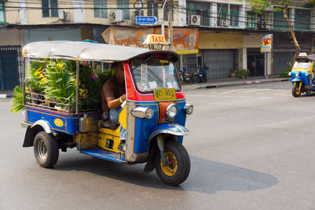 BANGKOK, THAILAND - MARCH 23: Unidentified man drives tuk tuk on March 23, 2014 in Bangkok, Thailand. Tuk tuk is inexpensive and popular form of transport in Bangkokのeditorial素材