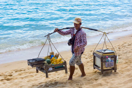 SAMUI, THAILAND - MARCH 30: Vendor sells fruits and local food on the beach on March 27, 2014 in Samui, Thailand.のeditorial素材