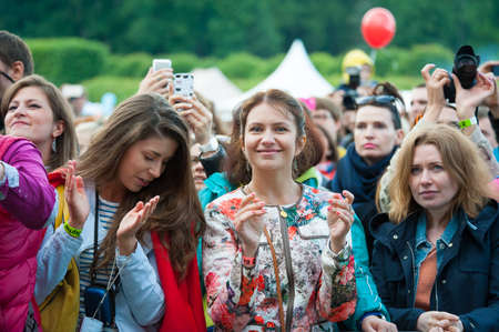 MOSCOW - JUNE 14: People cheering at open-air concert on XI International Jazz Festival "Usadba Jazz" in Archangelskoye Museum-Mansion on June 14, 2014 in Moscowのeditorial素材