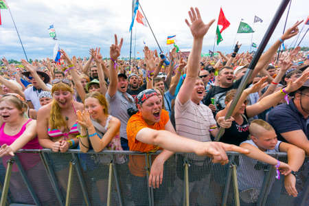 BIG ZAVIDOVO, RUSSIA - JULY 4: People cheering at open-air rock festival "Nashestvie" on July 4, 2014 in Big Zavidovo, Russia. "Nashestvie" is the biggest rock festival in Russia, more 200000 visitorsのeditorial素材