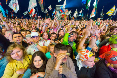 BIG ZAVIDOVO, RUSSIA - JULY 4: People cheering at open-air rock festival "Nashestvie" on July 4, 2014 in Big Zavidovo, Russia. "Nashestvie" is the biggest rock festival in Russia, more 200000 visitorsのeditorial素材