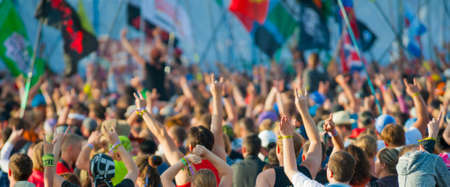 BIG ZAVIDOVO, RUSSIA - JULY 5: People cheering at open-air rock festival "Nashestvie" on July 5, 2014 in Big Zavidovo, Russia. "Nashestvie" is the biggest rock festival in Russia, more 200000 visitorsのeditorial素材