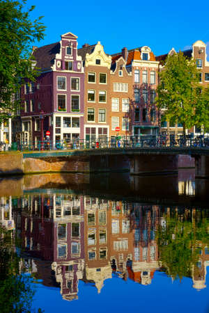 Traditional dutch buildings on canal in Amsterdamの写真素材