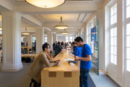 AMSTERDAM - AUGUST 28: Buyers and shop assistants at Apple store on August 28, 2014 in Amsterdam.のeditorial素材
