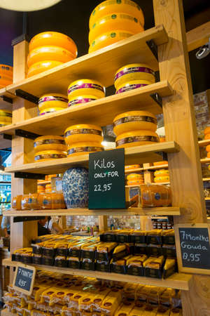 AMSTERDAM - AUGUST 29: Cheese wheels are on the shelves in the store on August 29, 2014 in Amsterdam.のeditorial素材