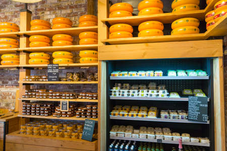 AMSTERDAM - AUGUST 29: Cheese wheels are on the shelves in the store on August 29, 2014 in Amsterdam.のeditorial素材
