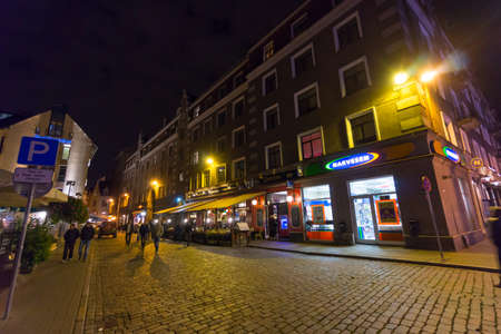 RIGA, LATVIA - SEPTEMBER 28: Tourists visit old town at night on September 28, 2014 in Riga, Latviaのeditorial素材