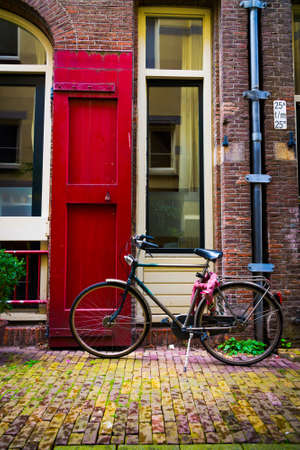 Traditional dutch bicycle parked at the front door in Amsterdamの写真素材