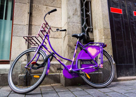 Traditional dutch bicycle parked at the front door in Amsterdamの写真素材