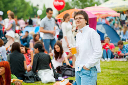 MOSCOW - JUNE 20, 2015: Young woman drinks beer on XII International Jazz Festival "Usadba Jazz" in Tsaritsyno Park on June 20, 2015 in Moscowのeditorial素材