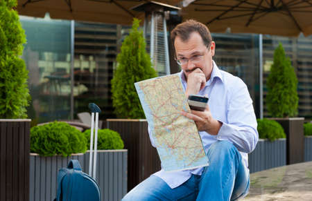 Middle age businessman exploring the city guide