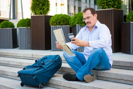 Middle age businessman exploring the city guide