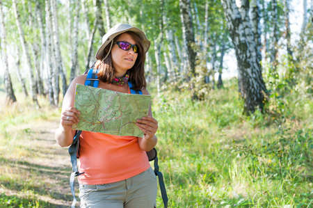 Young woman exploring the trekking map
