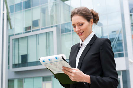 Young business woman portrait on the office building backgroundの写真素材