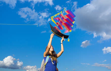 MOSCOW - AUGUST 30, 2015: Unidentified woman launches ship kite to the sky in Tsaritsyno Park on August 30, 2015 in Moscowのeditorial素材