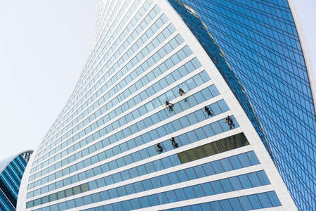 Window washers working on skyscraperの写真素材