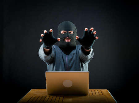 Hacker stretching his arms forward, he'll come for your laptop
