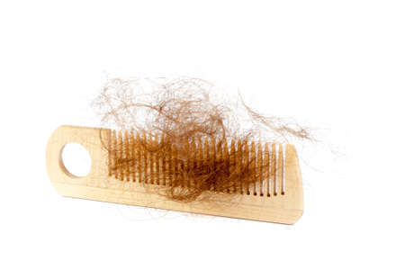 Bunch of hair on the comb. Hair loss concept