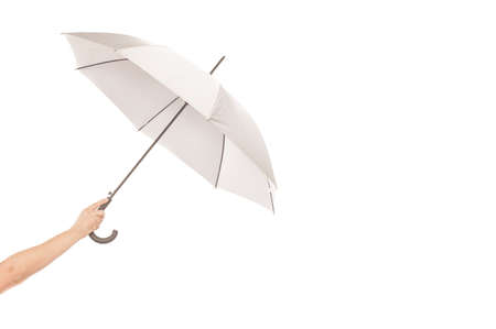 Umbrela in a hand isolated on whiteの写真素材
