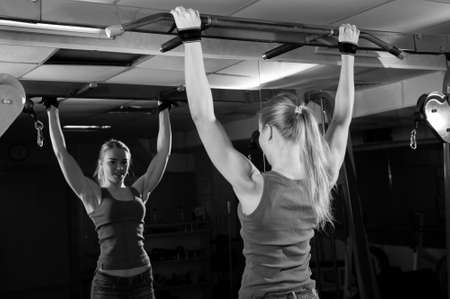 Young muscular woman doing workout at the gym