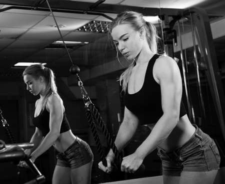 Young muscular woman doing workout at the gymの写真素材