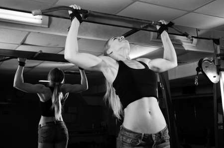 Young muscular woman doing workout at the gymの写真素材