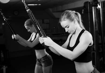 Young muscular woman doing workout at the gymの写真素材