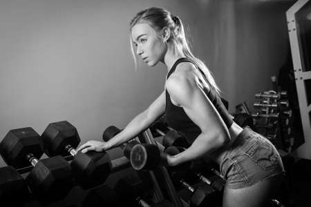 Young muscular woman doing workout at the gymの写真素材