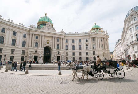 VIENNA - APRIL,24: Tourists ride in a fiakre in old city centre on April 24, 2016 in Viennaのeditorial素材
