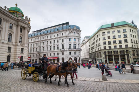 VIENNA - APRIL,24: Tourists ride in a fiakre in old city centre on April 24, 2016 in Viennaのeditorial素材