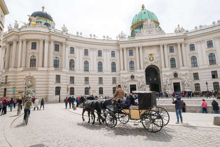 VIENNA - APRIL,24: Tourists ride in a fiakre in old city centre on April 24, 2016 in Viennaのeditorial素材