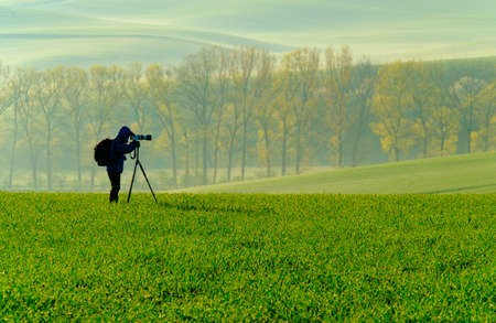 Nature photographer takes landscape pictureの写真素材