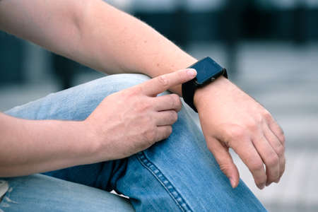 Man using smart watch outdoorsの写真素材