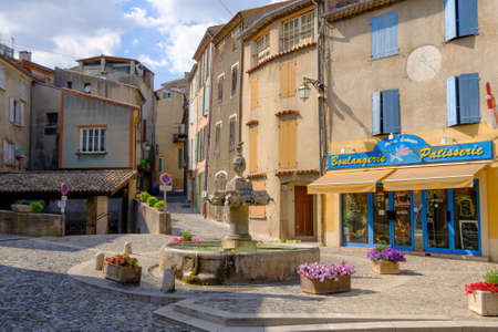 VALENSOLE, FRANCE - JULY 4. 2016: Central square with fountain and private shops at day timeのeditorial素材