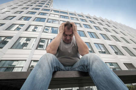Sad middle age man portrait outdoors. bottom viewの写真素材