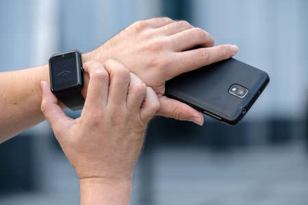 Man using smart watch outdoorsの写真素材