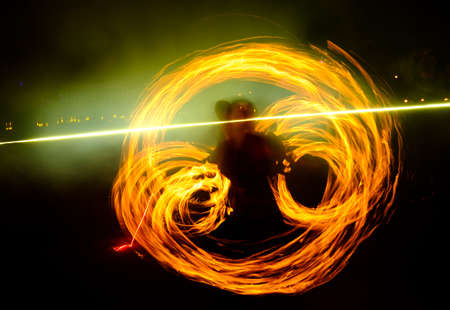 Fire show traces in the darkの写真素材