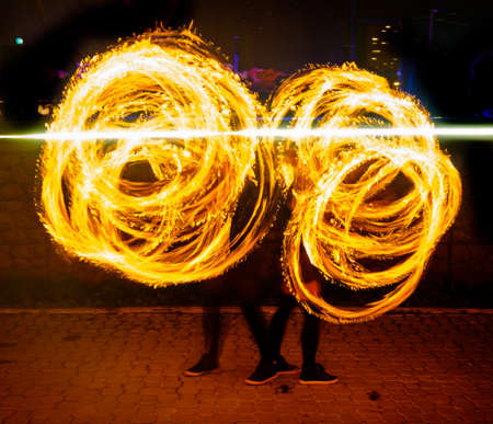 Fire show traces in the darkの写真素材