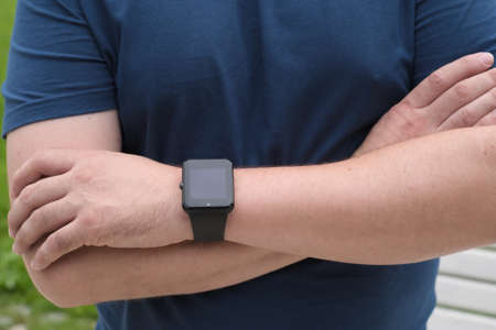 Man using smart watch outdoors