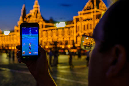 Moscow, Russia - July 31: Male hand holding a smartphone with a running modern augmented reality...
