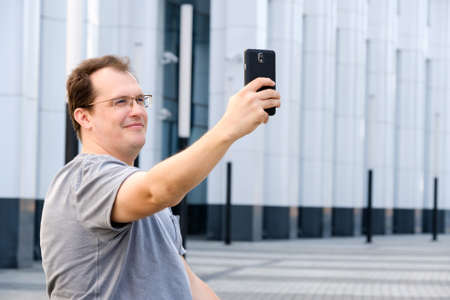 Middle age man making selfie outdoorsの写真素材