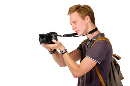 Young man traveler taking pictures by dslr camera isolated on white