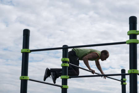 Moscow, Russia - September 10, 2016: Young man practice street workout on open competition dedicated to City Dayのeditorial素材