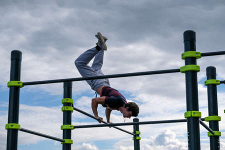 Moscow, Russia - September 10, 2016: Young man practice street workout on open competition dedicated to City Dayのeditorial素材