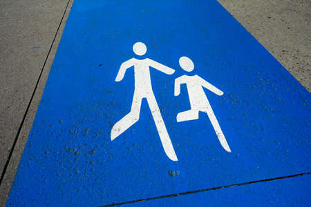 Pedestrians sign on the sidewalkの写真素材