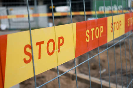 stop sign ribbon on a construction siteの写真素材