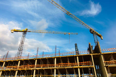 Building construction site at sunny day, blue cloudy sky