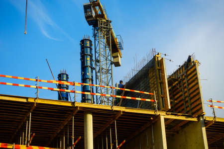 Building construction site at sunny day, blue cloudy skyの写真素材